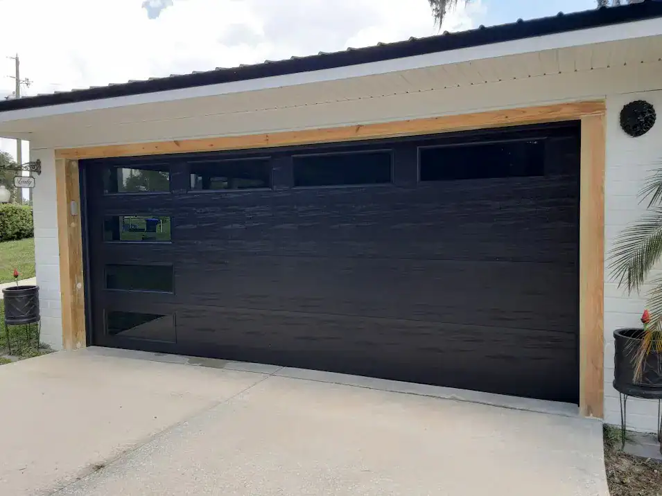 Black Amarr Heritage 3000 garage door with tinted windows installed in DeLand, FL