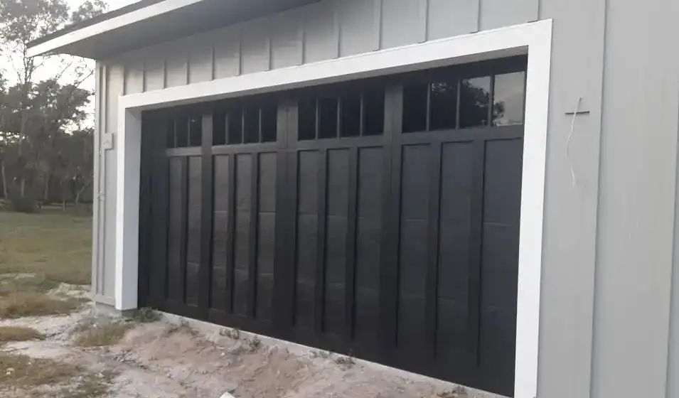 Black Haas American Traditions 9622 garage door with decorative overlays and dark gray windows in DeLand, FL